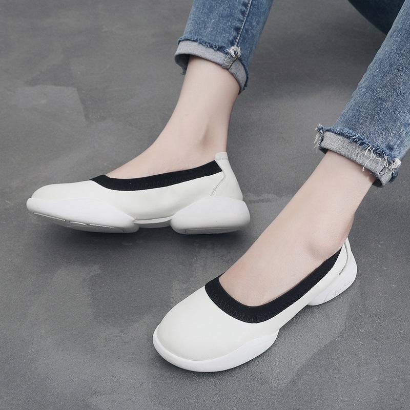 A pair of black and white women's fashion sneakers